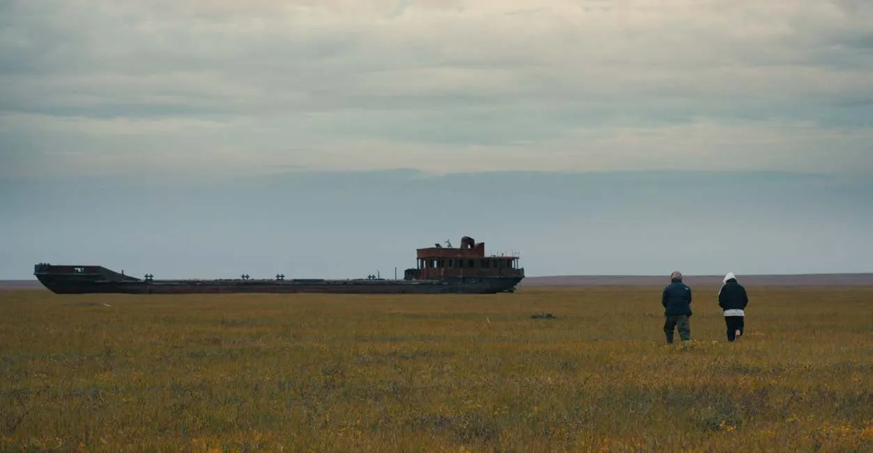 The Arctic tundra stretches towards a distant horizon.